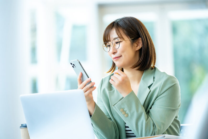 スマホで調べ物をする女性